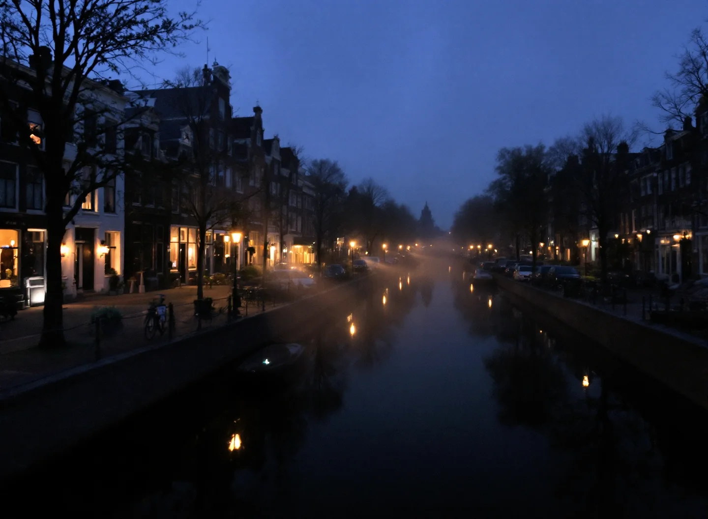 A Dutch canal at blue hour, warm window lights reflected on still water